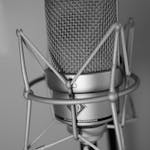 Close-up of a high-end condenser microphone in black and white, ideal for studio recording.