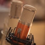 Detailed close-up of a modern studio microphone suitable for audio recording.